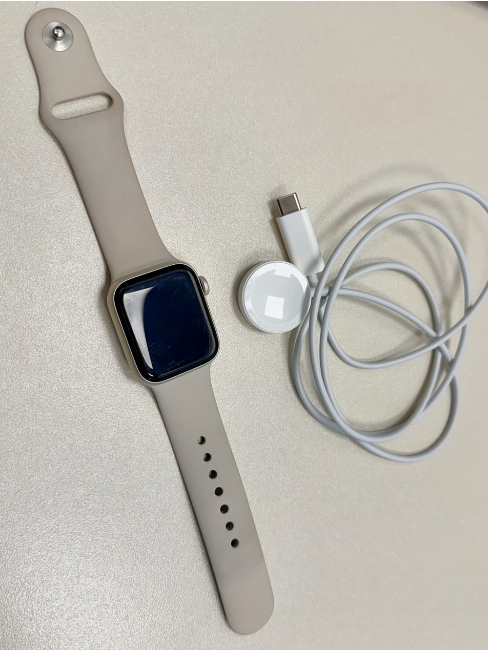 Apple Smartwatch with Light Beige Silicone Band and White Charger